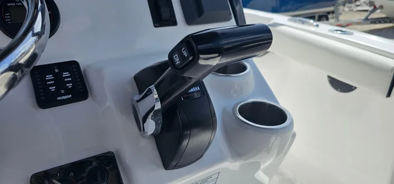Slide: The Image of 2023 Tidewater 232 LXF boat throttle and cup holders on console. - 8