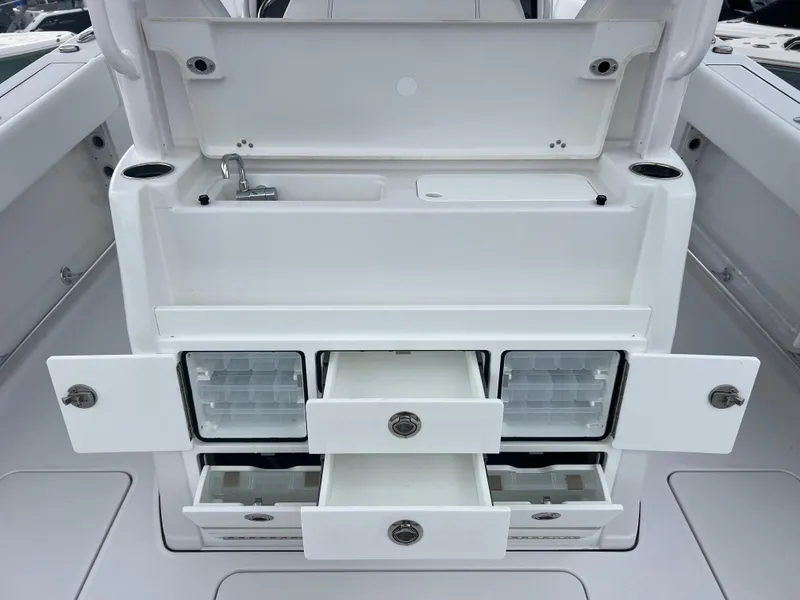 Slide: The Image of 2025 Sportsman Open 322 Center Console with storage compartments and sink. - 10