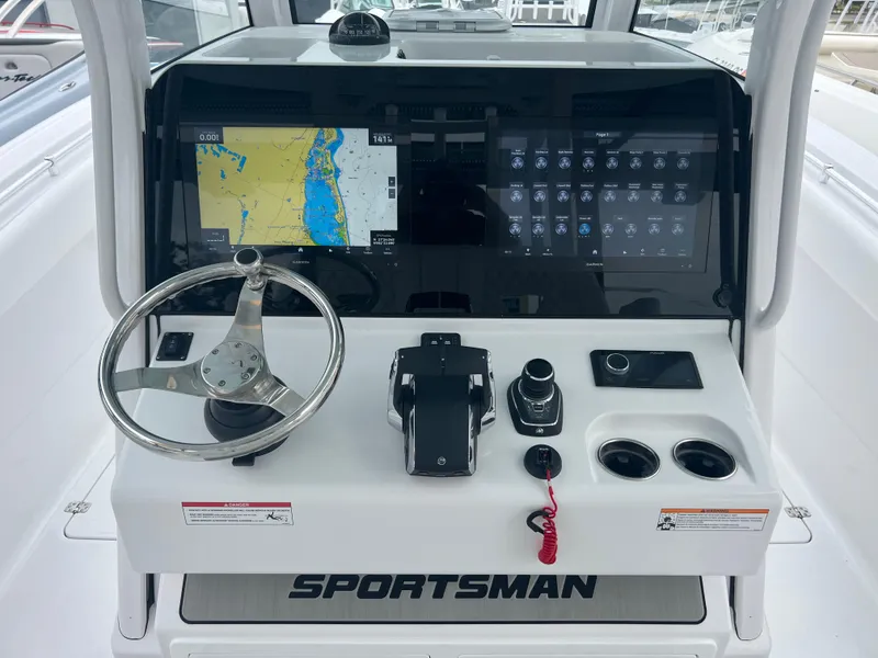 Slide: The Image of 2024 Sportsman Open 322 Center Console dashboard with navigation and control systems. - 12