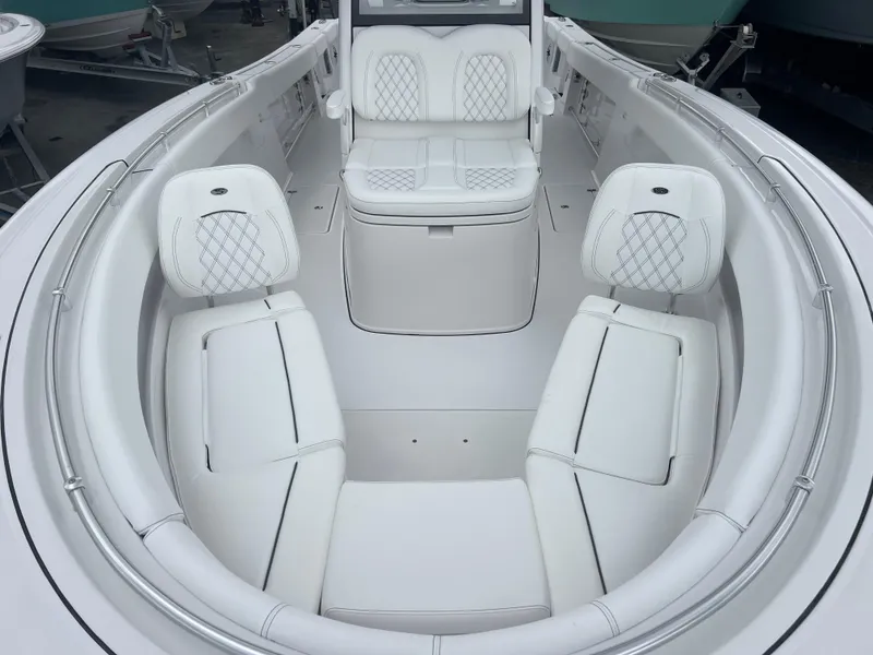 Slide: The Image of 2025 Sportsman Open 322 Center Console boat interior with white cushioned seating. - 15