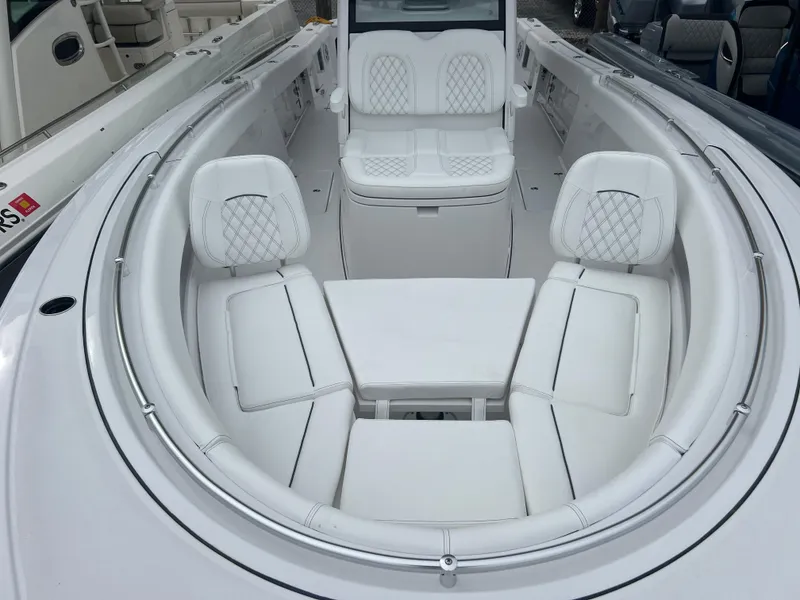 Slide: The Image of 2024 Sportsman Open 322 Center Console boat with luxurious white seating. - 16