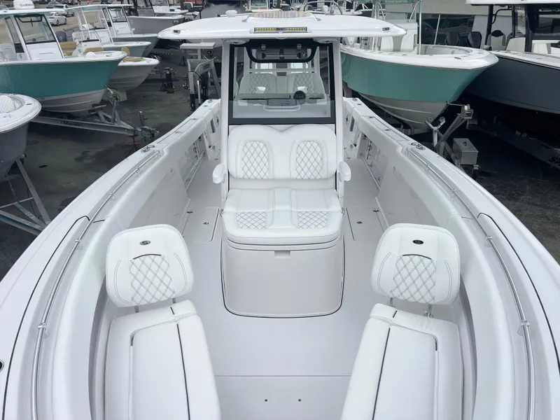 Slide: The Image of 2025 Sportsman Open 322 Center Console boat with white seating and sleek design. - 17
