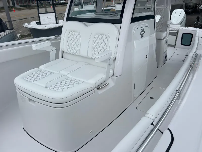 Slide: The Image of 2025 Sportsman Open 322 Center Console boat with white seating and sleek design. - 18