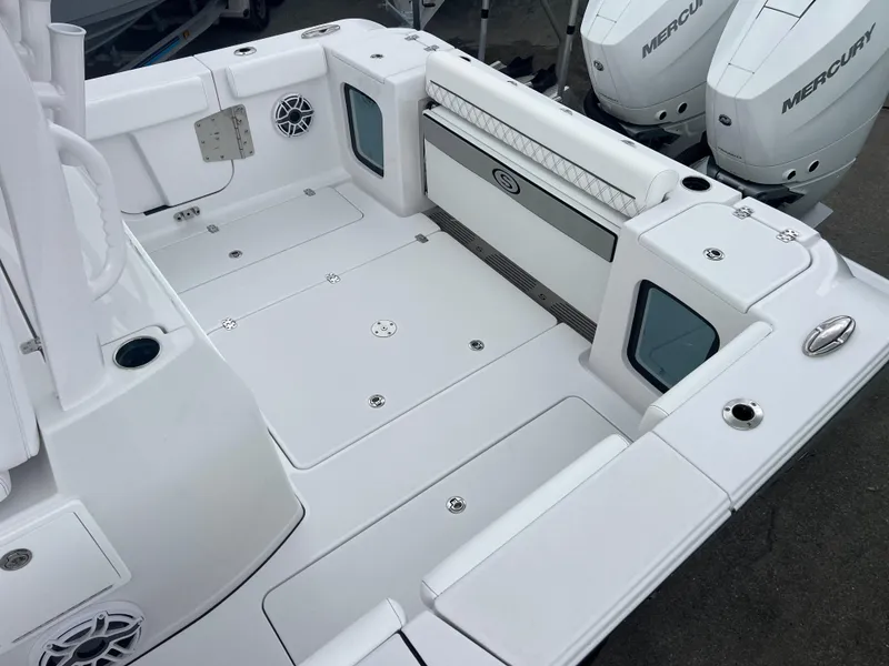 Slide: The Image of 2025 Sportsman Open 322 Center Console boat deck with Mercury engines, spacious and modern design. - 22