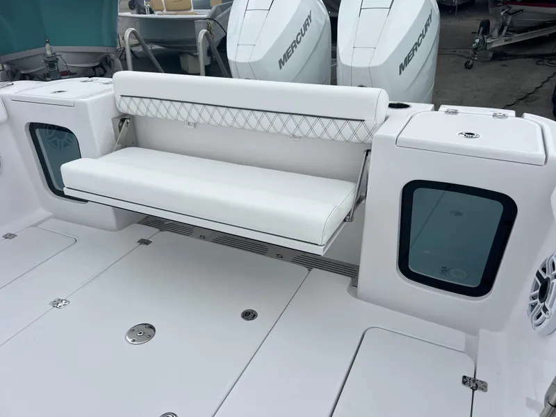 Slide: The Image of 2025 Sportsman Open 322 Center Console boat with white seating and dual Mercury engines. - 23