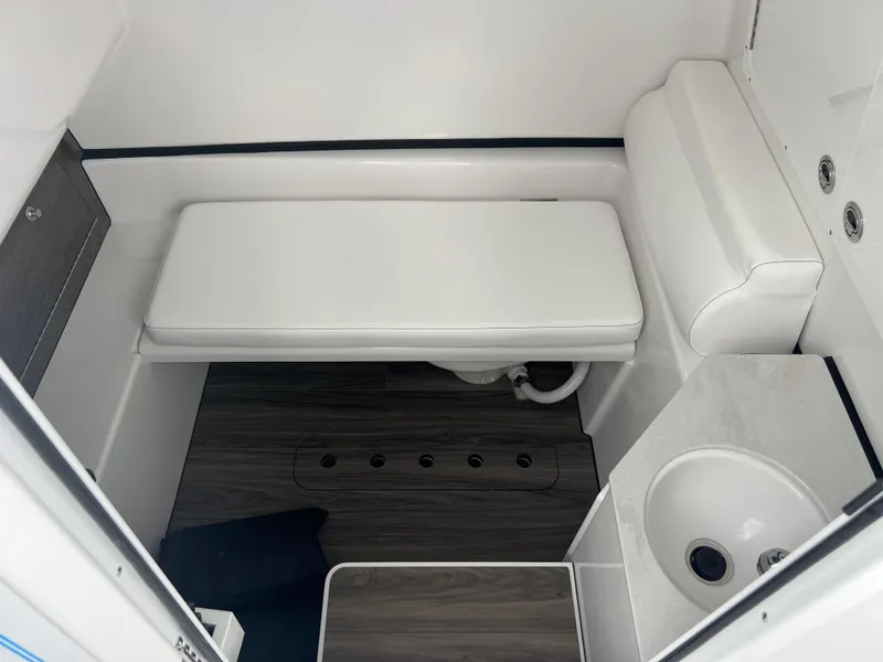 Slide: The Image of 2025 Sportsman Open 322 Center Console interior with seating and sink. - 24