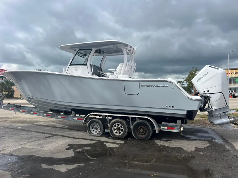 Slide: The Image of 2025 Sportsman Open 322 Center Console boat on trailer, cloudy sky background. - 3