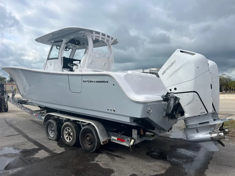 Slide: The Image of 2025 Sportsman Open 322 Center Console boat on trailer, featuring powerful outboard engine. - 4