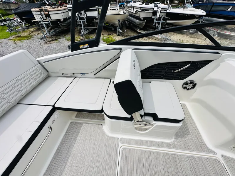 Slide: The Image of 2025 Sea Ray SPX 210 boat interior with white seating and modern design. - 11