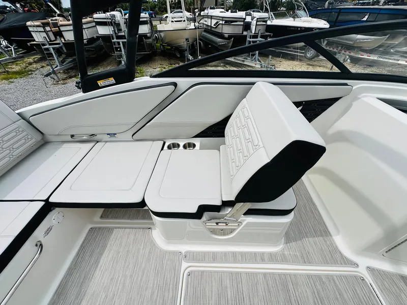 Slide: The Image of Interior seating of 2025 Sea Ray SPX 210 boat with white upholstery and cup holders. - 12