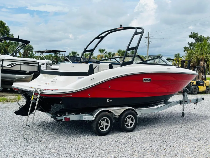 Slide: The Image of 2025 Sea Ray SPX 210 boat with red and white exterior on a trailer. - 2