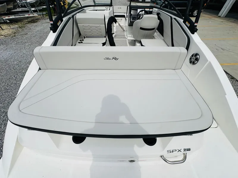 Slide: The Image of 2025 Sea Ray SPX 210 boat interior with white seating and modern design. - 9