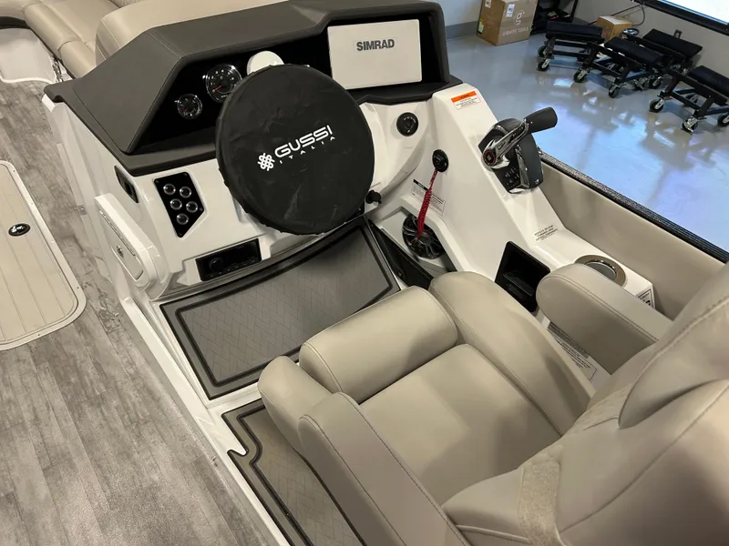 Slide: The Image of 2024 Crest Caribbean Platinum 250 SLRC CP3 boat interior with steering wheel and captain's chair. - 11