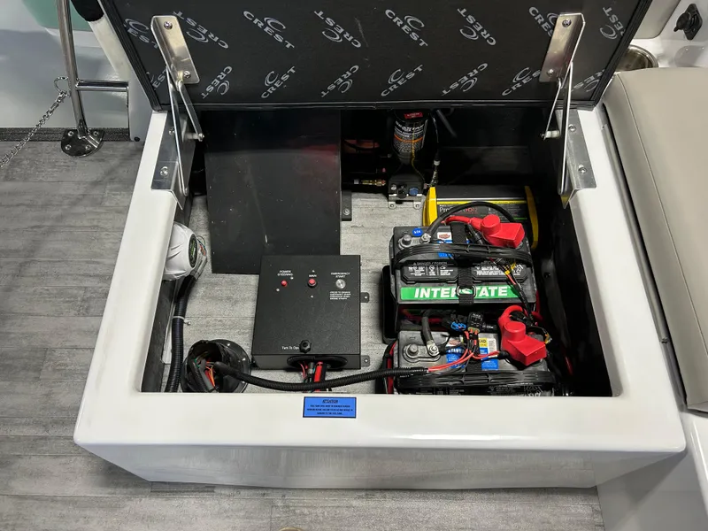 Slide: The Image of 2024 Crest Caribbean Platinum 250 SLRC CP3 boat battery compartment and electrical components. - 15