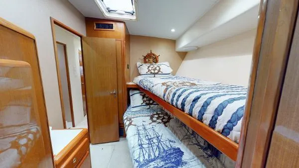 Slide: The Image of Cabin interior of 1999 Viking 72 Sport Fish with bunk beds and nautical decor. - 13