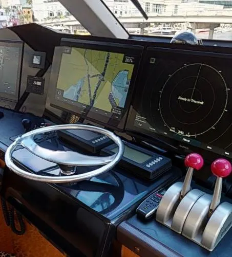 Slide: The Image of Cockpit of a 1999 Viking 72 Sport Fish yacht with navigation and control systems. - 16