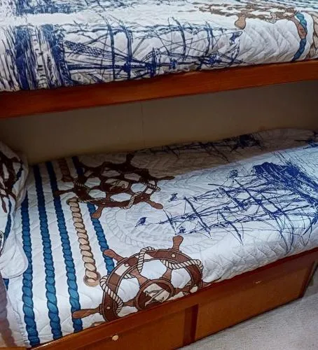 Slide: The Image of Bunk beds with nautical-themed bedding on a 1999 Viking 72 Sport Fish yacht. - 18