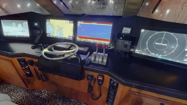 Slide: The Image of 1999 Viking 72 Sport Fish boat cockpit with advanced navigation systems and controls. - 19