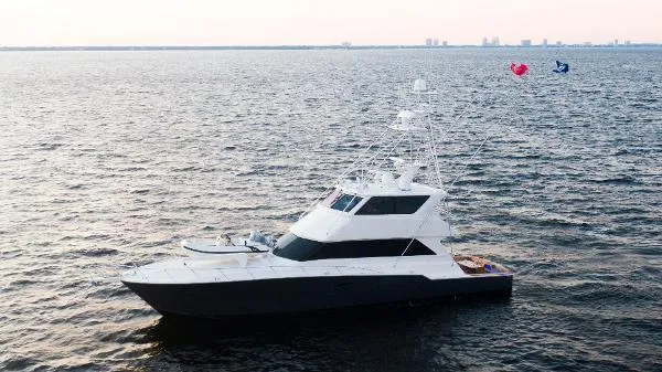 Slide: The Image of 1999 Viking 72 Sport Fish yacht cruising on open water. - 2