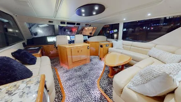 Slide: The Image of Luxurious interior of a 1999 Viking 72 Sport Fish yacht with plush seating and modern decor. - 21