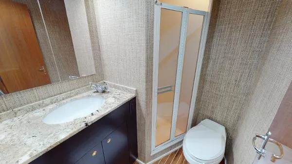 Slide: The Image of 1999 Viking 72 Sport Fish yacht bathroom with shower, sink, and toilet. - 25