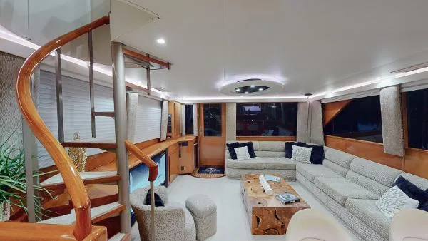 Slide: The Image of Luxurious interior of a 1999 Viking 72 Sport Fish yacht with spiral staircase and plush seating. - 30