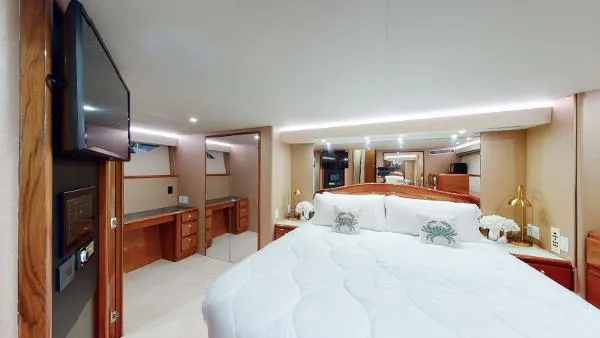 Slide: The Image of Luxurious bedroom interior of a 1999 Viking 72 Sport Fish yacht with modern amenities. - 33