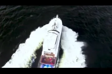 Slide: The Image of Aerial view of a 1999 Viking 72 Sport Fish boat cruising on water. - 5