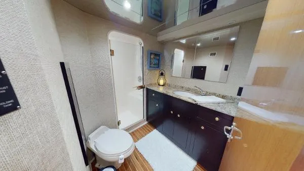 Slide: The Image of 1999 Viking 72 Sport Fish yacht bathroom with shower, toilet, and vanity. - 7