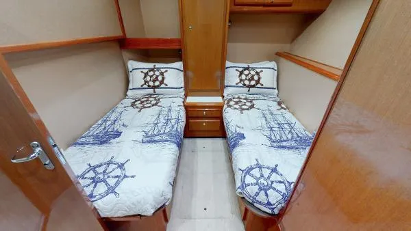 Slide: The Image of Twin cabin beds in 1999 Viking 72 Sport Fish yacht with nautical-themed bedding. - 8