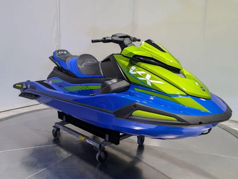 Slide: The Image of 2024 Yamaha Boats VX® Limited HO, blue and green jet ski on display stand. - 28
