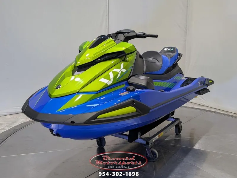 Slide: The Image of 2024 Yamaha Boats VX® Limited HO in vibrant green and blue on display stand. - 3