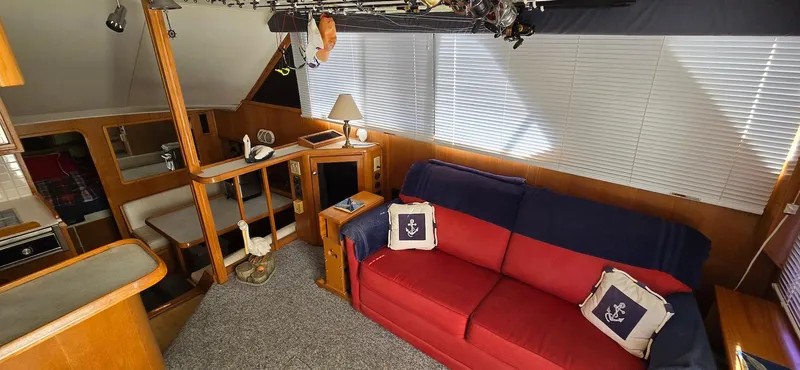 Slide: The Image of Interior of 1989 Chris-Craft 392 Commander with red sofa and nautical decor. - 10