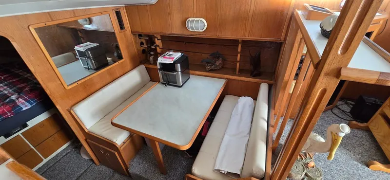Slide: The Image of 1989 Chris-Craft 392 Commander interior dining area with table and seating. - 11