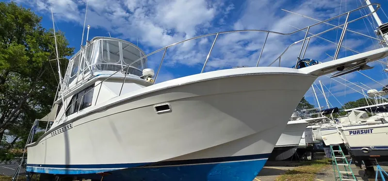 Slide: The Image of 1989 Chris-Craft 392 Commander yacht docked under a blue sky. - 2