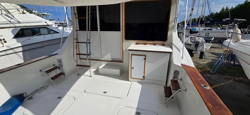 Slide: The Image of 1989 Chris-Craft 392 Commander yacht deck with seating and storage. - 7