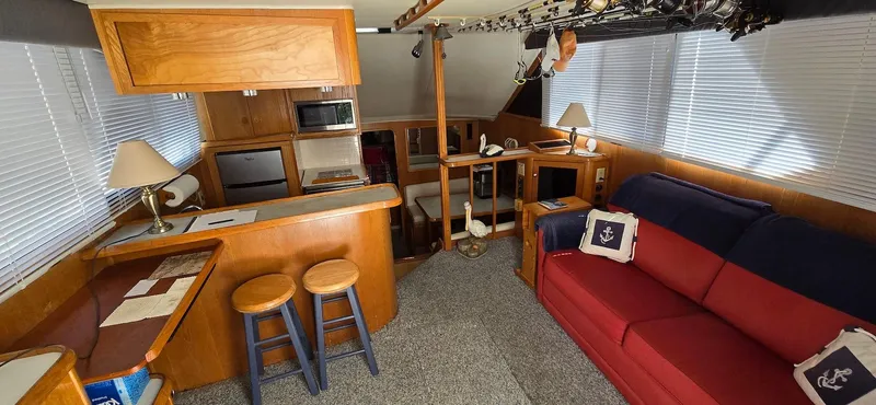 Slide: The Image of Interior of 1989 Chris-Craft 392 Commander yacht with kitchen and seating area. - 8