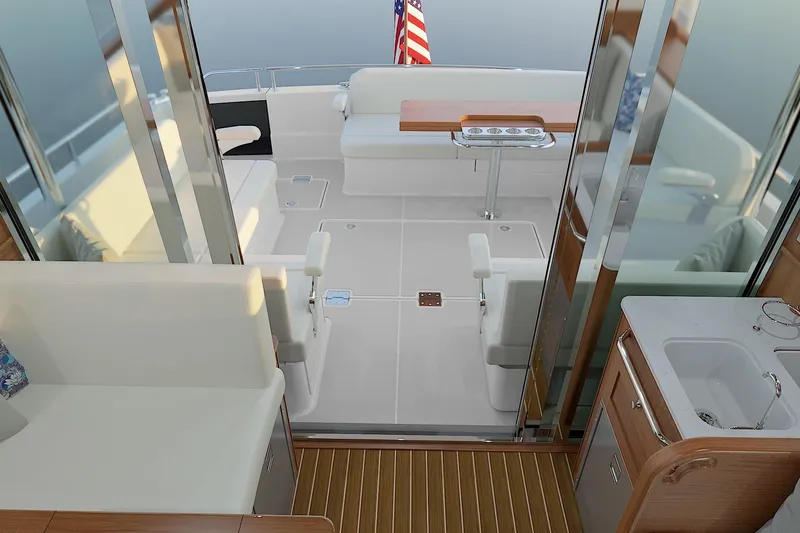 Slide: The Image of Luxurious interior of 2026 Sabre 51 Salon Express yacht with elegant seating and American flag. - 6