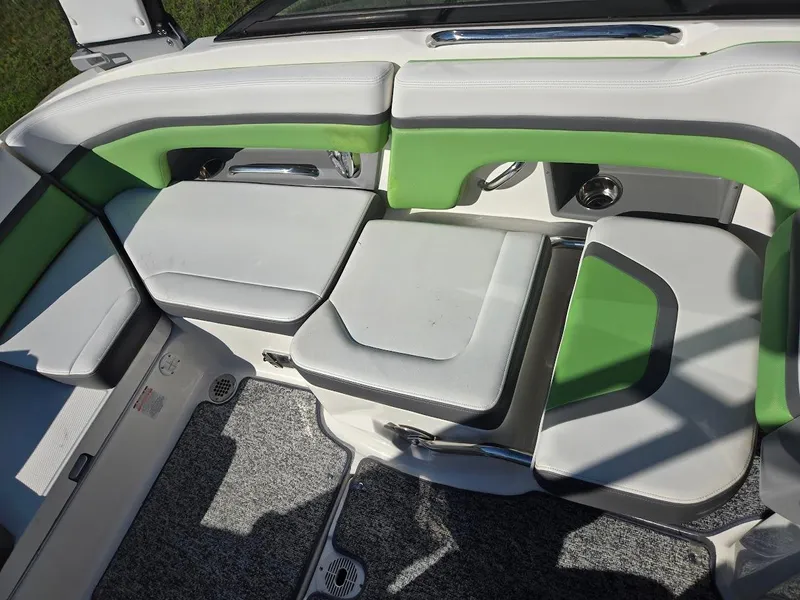Slide: The Image of 2015 Chaparral 203V boat interior with green and white seating. - 10