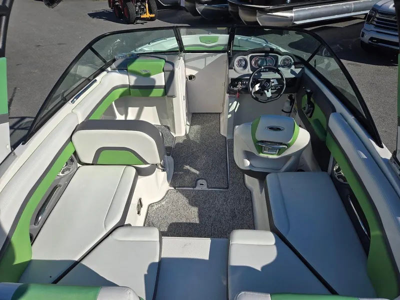 Slide: The Image of 2015 Chaparral 203V boat interior with green and white seating. - 4