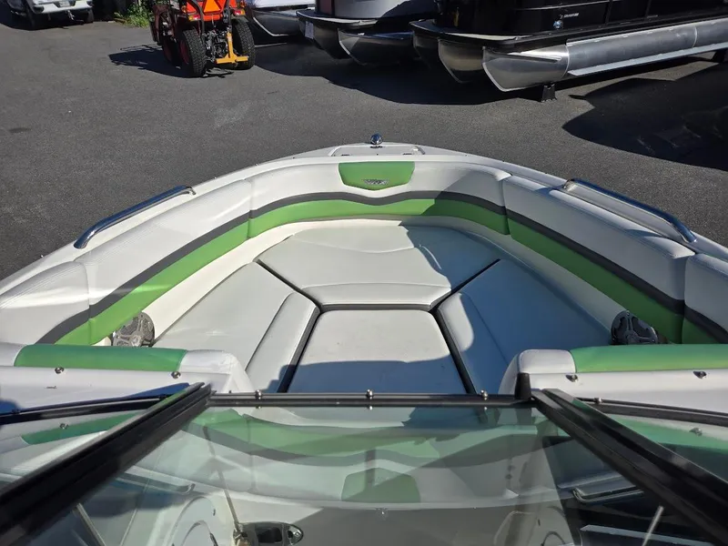 Slide: The Image of 2015 Chaparral 203V boat with green and white interior, bow seating area. - 5