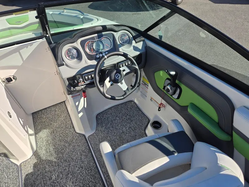 Slide: The Image of 2015 Chaparral 203V boat cockpit with steering wheel and dashboard. - 7