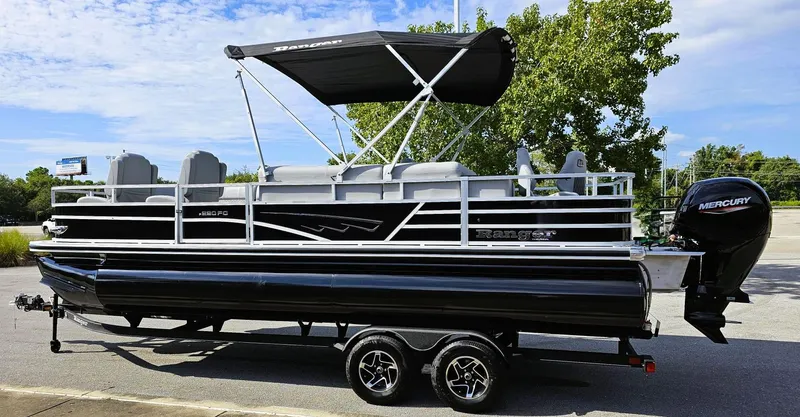 Slide: The Image of 2024 Ranger Reata 220FC pontoon boat with canopy and Mercury outboard motor. - 8