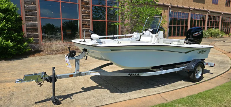 Slide: The Image of 2024 Mako Pro Skiff 15 CC boat on trailer, parked outdoors. - 0