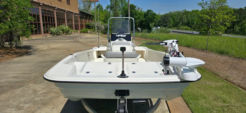 Slide: The Image of 2024 Mako Pro Skiff 15 CC boat on trailer, parked outdoors. - 3