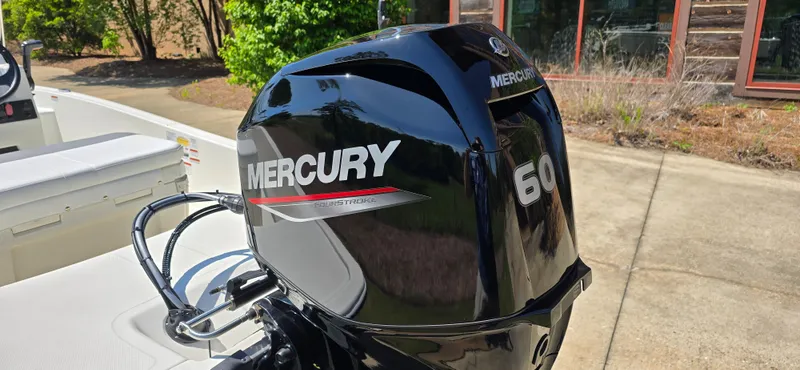 Slide: The Image of 2024 Mako Pro Skiff 15 CC with Mercury 60 outboard motor in outdoor setting. - 6
