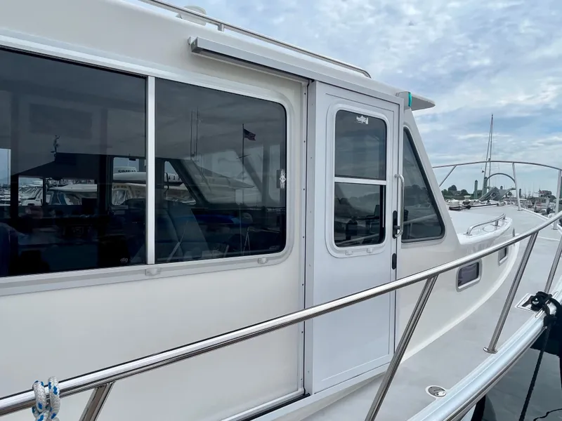 Slide: The Image of 2016 Wesmac 42 boat deck with seating, life preserver, and marina view. - 11