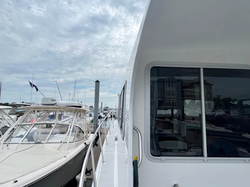 Slide: The Image of Wesmac 42 boat docked at marina, 2016 model, with visible anchor and deck. - 21