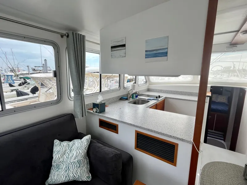 Slide: The Image of Cozy interior of 2016 Wesmac 42 boat with sofa and wooden table. - 25