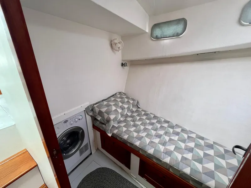 Slide: The Image of Wooden drawers on a 2016 Wesmac 42 boat, featuring a blue patterned cushion. - 47